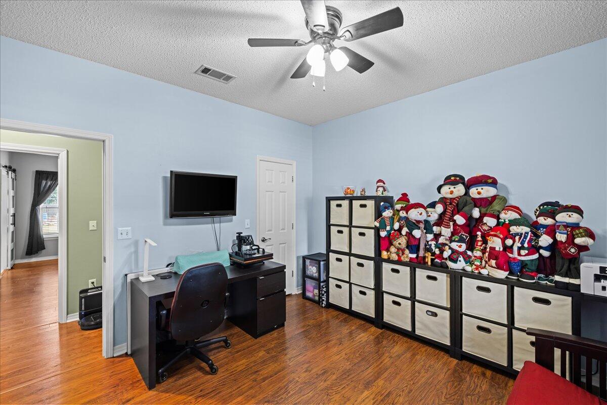 306 Tala Way Niceville, FL 32578 - Photo 22 of 47 a bedroom with furniture a flat screen tv and a window