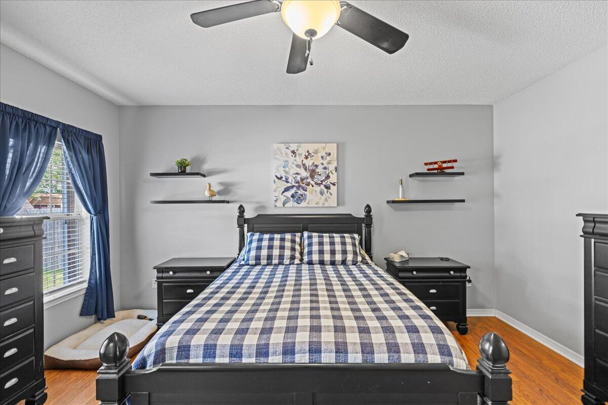 306 Tala Way Niceville, FL 32578 - Photo 24 of 47 a bedroom with a bed and a chandelier
