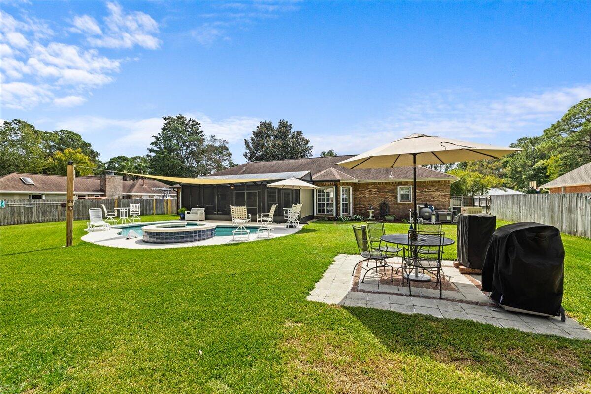 306 Tala Way Niceville, FL 32578 - Photo 35 of 47 a view of a swimming pool with a table and chairs under an umbrella