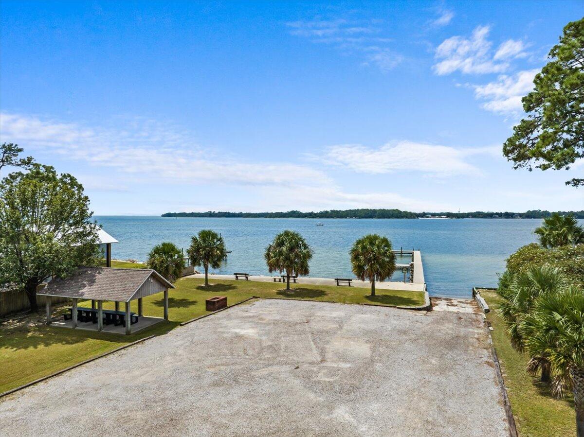 306 Tala Way Niceville, FL 32578 - Photo 45 of 47 a view of swimming pool with outdoor seating and lake view