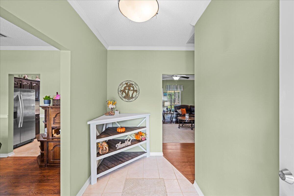306 Tala Way Niceville, FL 32578 - Photo 5 of 47 a view of a hallway to room with wooden floor and furniture