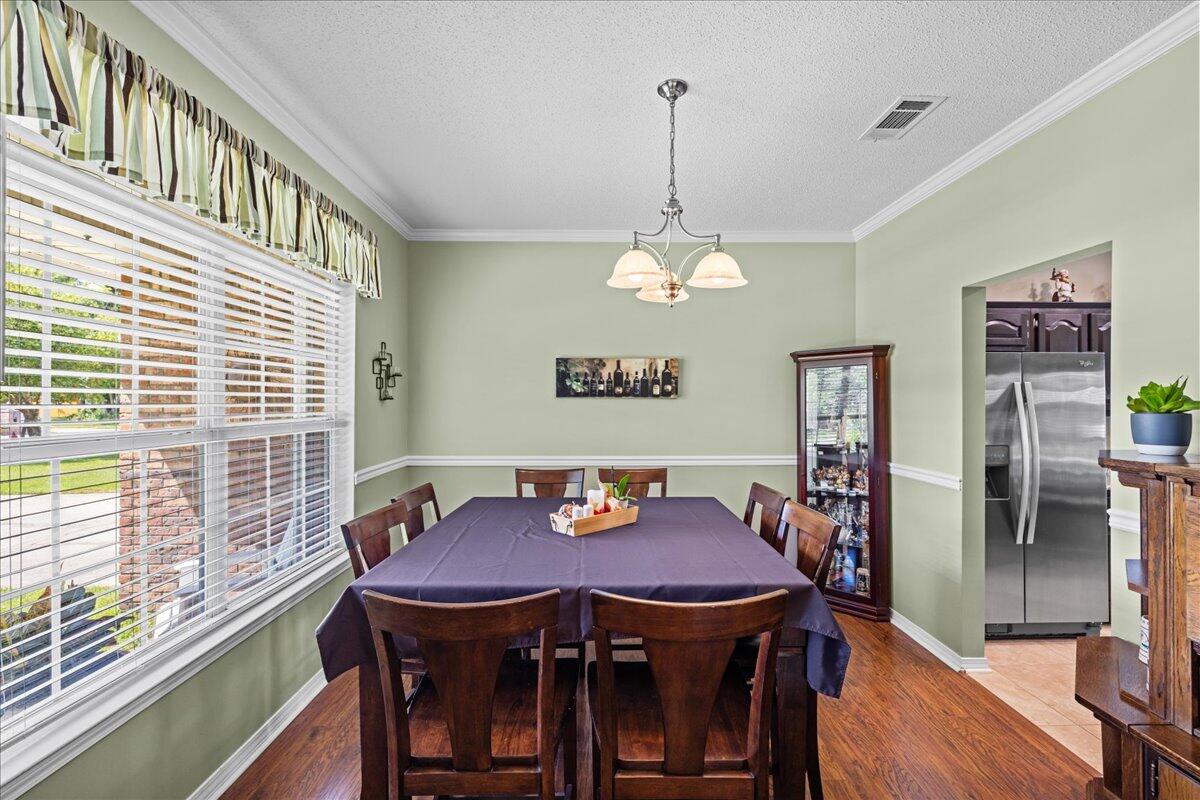 306 Tala Way Niceville, FL 32578 - Photo 6 of 47 a view of a dining room with furniture and chandelier