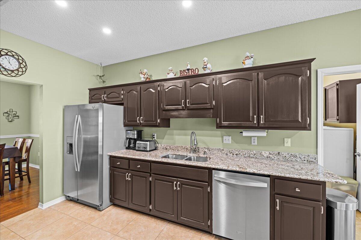 306 Tala Way Niceville, FL 32578 - Photo 10 of 47 a kitchen with stainless steel appliances granite countertop a sink refrigerator and cabinets