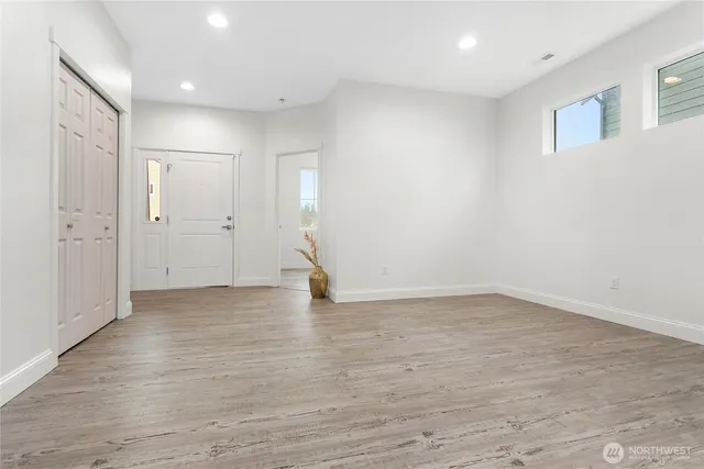 a view of an empty room with wooden floor
