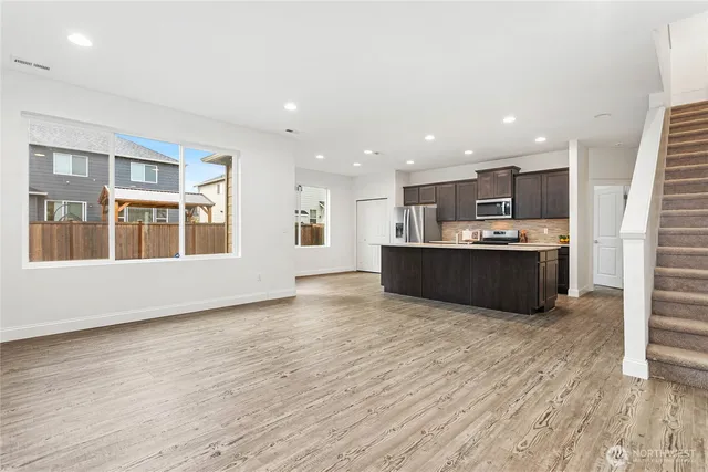 a view of kitchen with wooden floor and windows