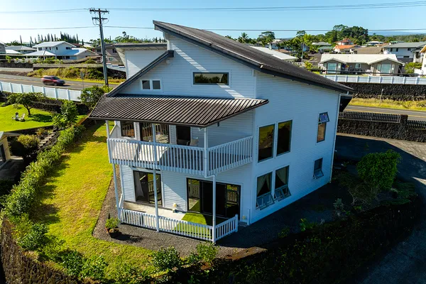 a aerial view of a house with swimming pool next to a yard