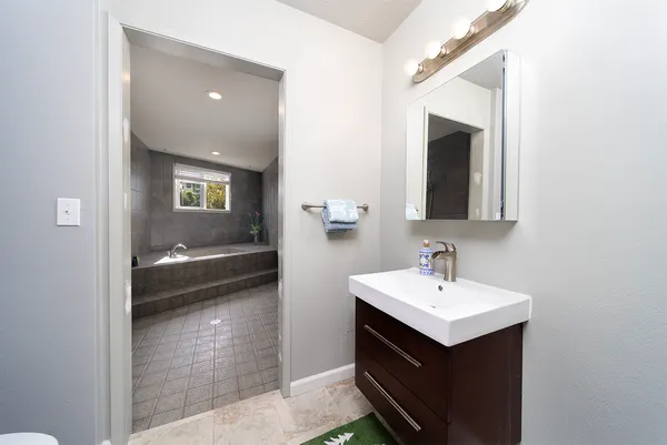 a en suite bathroom with a sink and mirror