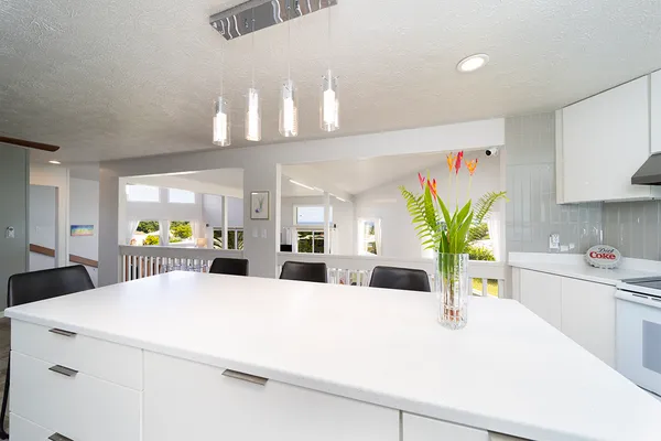 a view of living room with kitchen island furniture and a potted plant