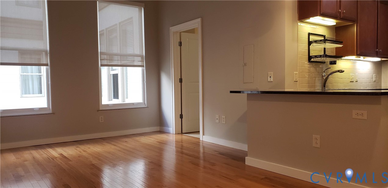 230 North 6th Street, Unit U613 Richmond, VA 23219 - Photo 4 of 10 a view of a room with wooden floor and cabinet