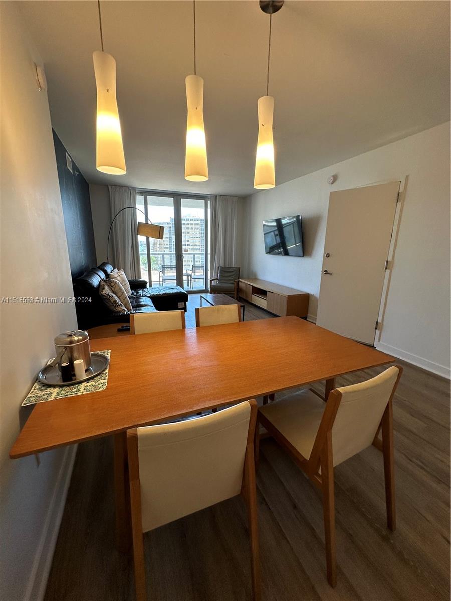 2602 East Hallandale Beach Boulevard, Unit R807 Hallandale Beach, FL 33009 - Photo 16 of 37 a room with wooden floor pool table and windows