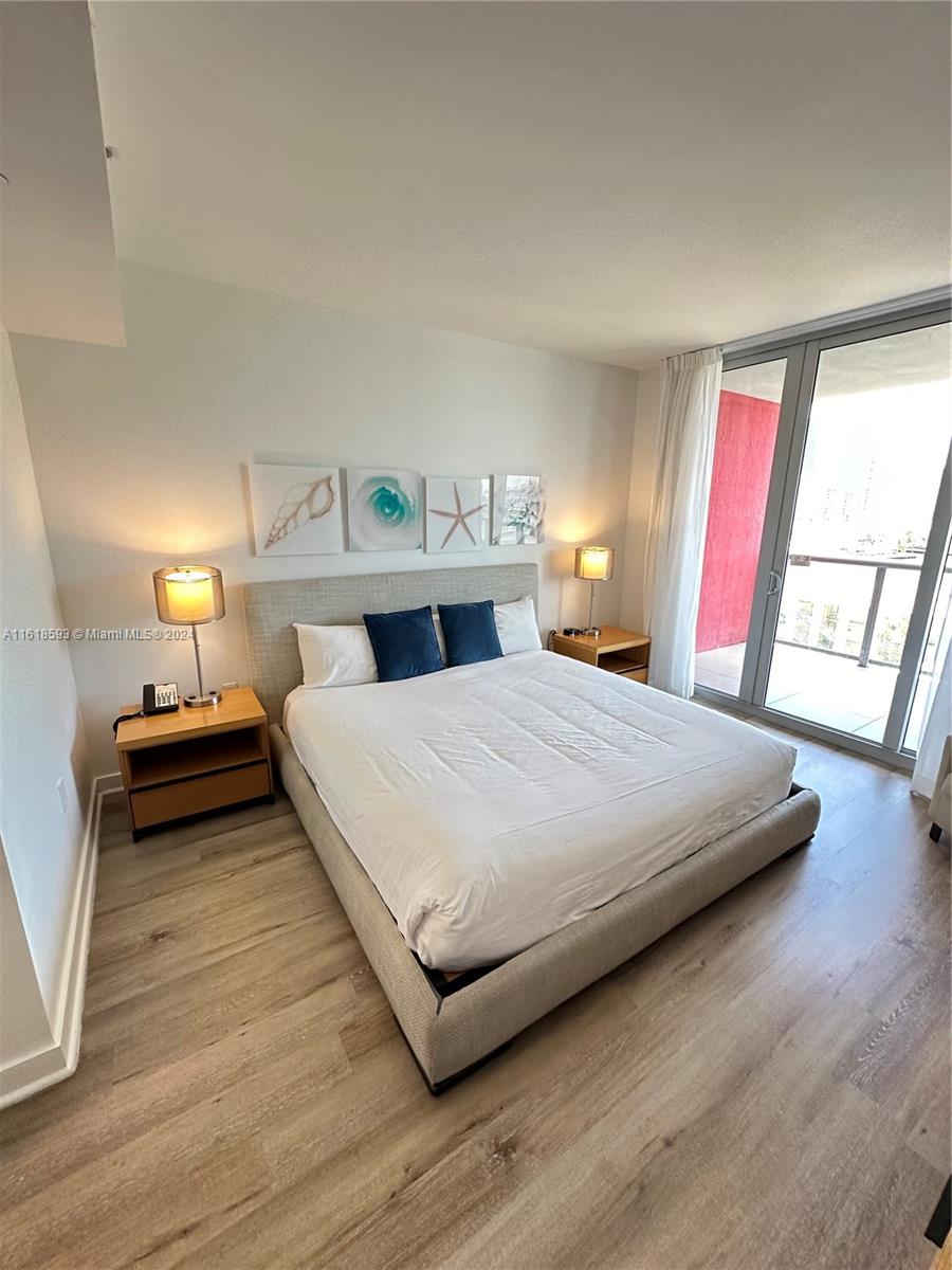 2602 East Hallandale Beach Boulevard, Unit R807 Hallandale Beach, FL 33009 - Photo 29 of 37 a bedroom with a bed and window