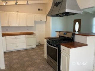 301 North Florence Street Ridgecrest, CA 93555 - Photo 11 of 33 a kitchen with stainless steel appliances granite countertop a stove and a sink