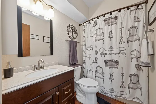 a bathroom with a toilet sink and mirror