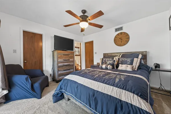 a bedroom with a bed and a television