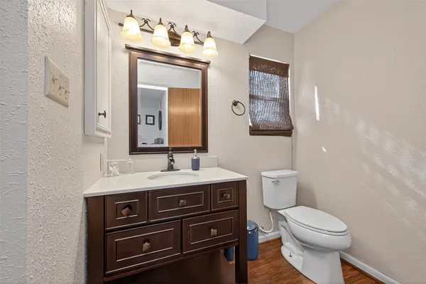 a bathroom with a toilet a sink and mirror