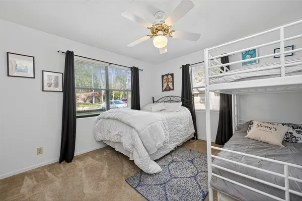 a bedroom with a large bed and a chandelier