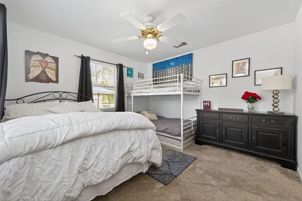a bedroom with a bed and a dresser