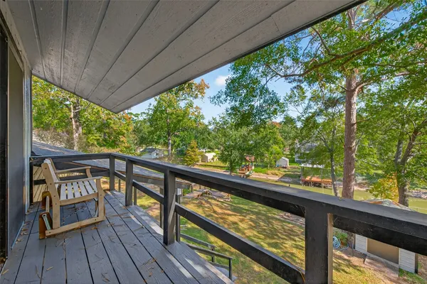 a view of a balcony with wooden floor