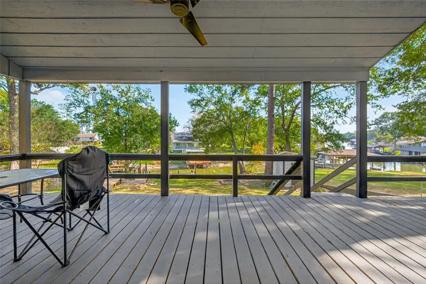 a view of a two chairs in the deck under a large umbrella