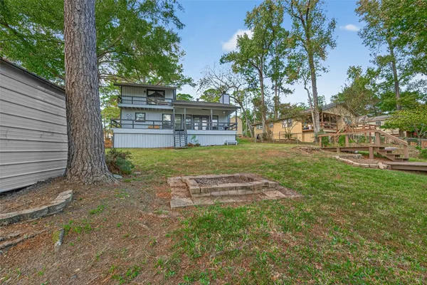 a view of a house with backyard porch and sitting area