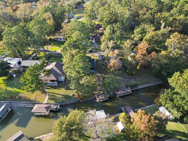 an aerial view of lake residential house with swimming pool and outdoor seating
