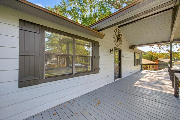 a view of backyard with large window and wooden floor