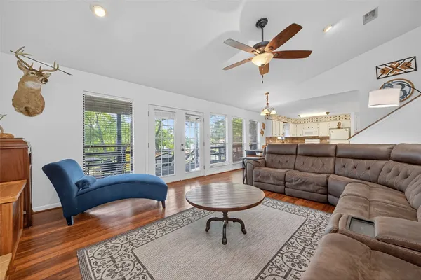 a living room with furniture a chandelier and a window