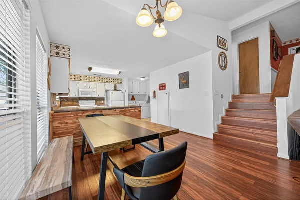 a view of a dining room with furniture and wooden floor