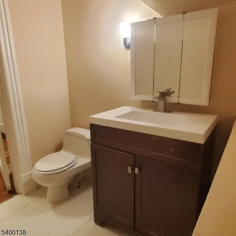 a bathroom with a sink toilet and mirror