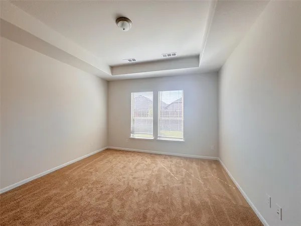 an empty room with a empty space and windows