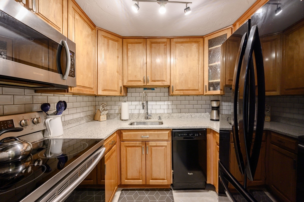 53 Will Drive, Unit 143 Canton, MA 02021 - Photo 1 of 23 a kitchen with stainless steel appliances granite countertop a sink stove and refrigerator