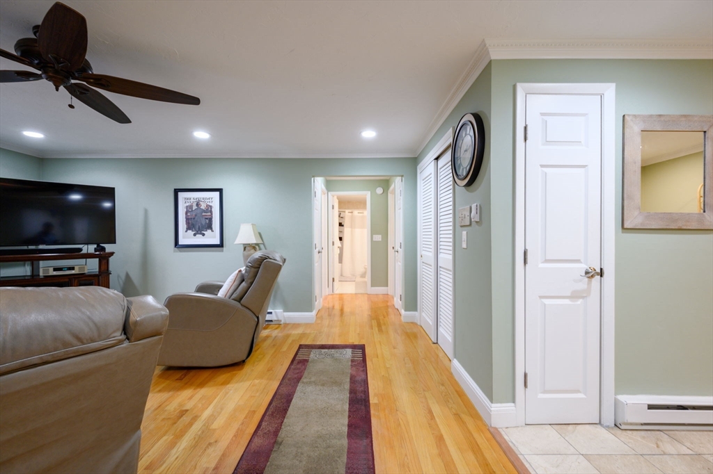 53 Will Drive, Unit 143 Canton, MA 02021 - Photo 11 of 23 a living room with furniture and a flat screen tv