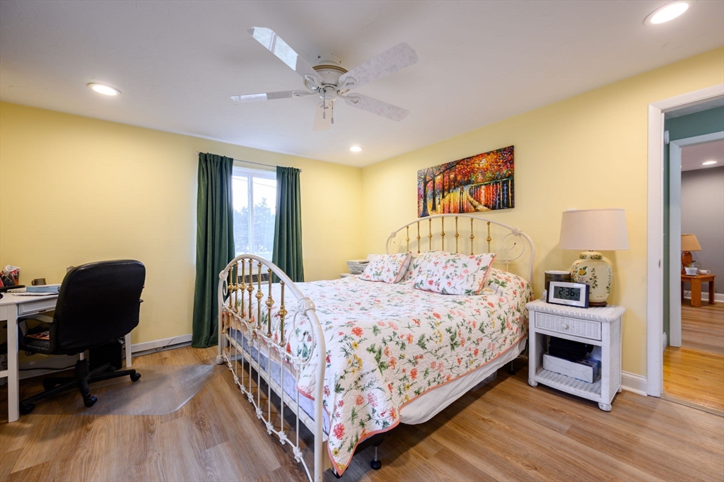 53 Will Drive, Unit 143 Canton, MA 02021 - Photo 12 of 23 a bedroom with a bed and a chair