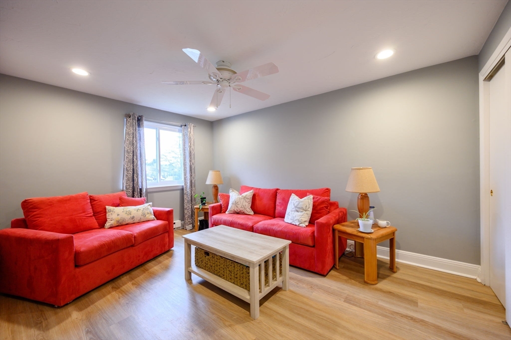 53 Will Drive, Unit 143 Canton, MA 02021 - Photo 14 of 23 a living room with furniture and a wooden floor