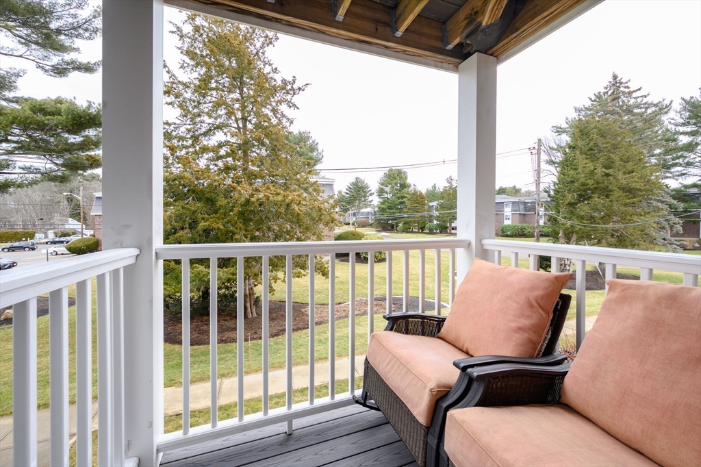 53 Will Drive, Unit 143 Canton, MA 02021 - Photo 17 of 23 a view of a chair and table in the balcony