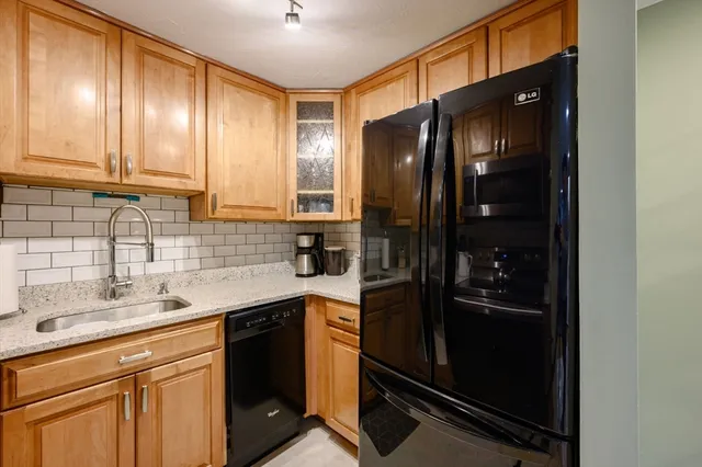 a kitchen with a refrigerator and a sink