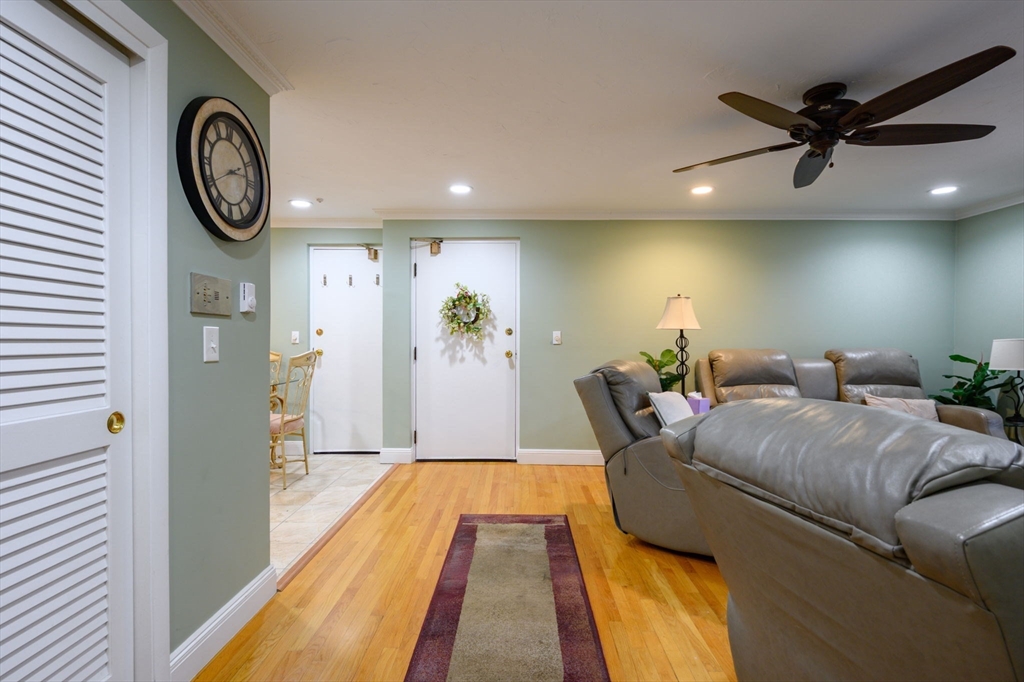 53 Will Drive, Unit 143 Canton, MA 02021 - Photo 10 of 23 a living room with furniture and a clock