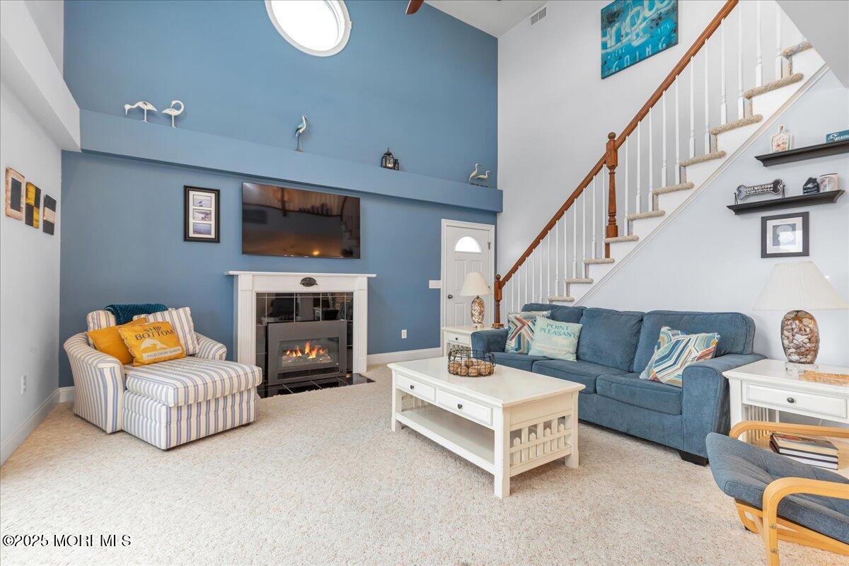 186 Flamingo Road Tuckerton, NJ 08087 - Photo 12 of 55 a living room with furniture a fireplace and a flat screen tv