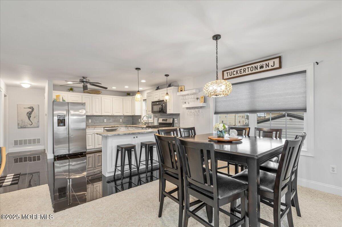 186 Flamingo Road Tuckerton, NJ 08087 - Photo 13 of 55 a open dining room with stainless steel appliances kitchen island a table and chairs