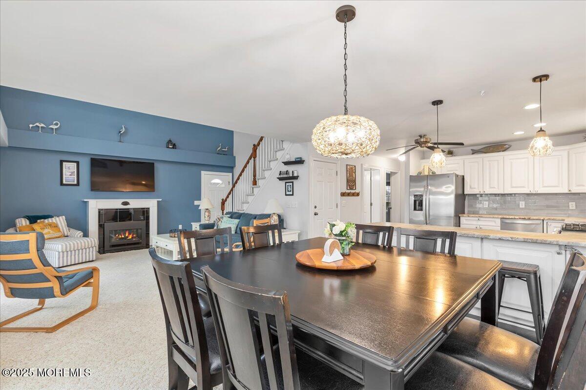 186 Flamingo Road Tuckerton, NJ 08087 - Photo 16 of 55 a view of a dining room with furniture a chandelier and wooden floor