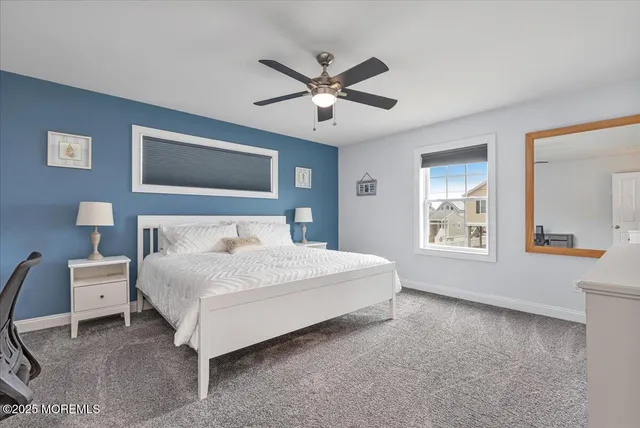 a bedroom with a bed chandelier and a desk