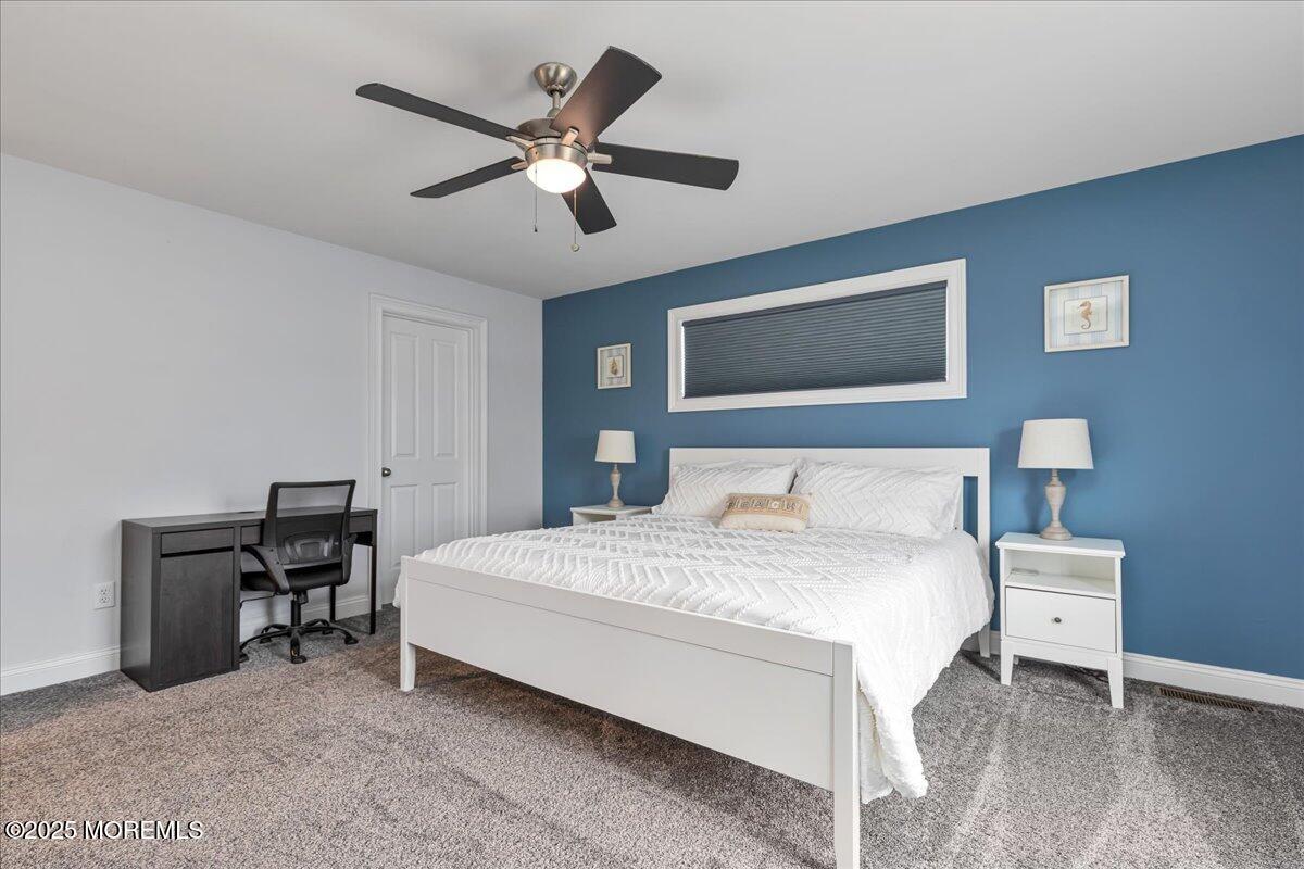 186 Flamingo Road Tuckerton, NJ 08087 - Photo 22 of 55 a bedroom with a bed chandelier and a desk