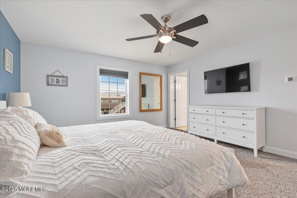 186 Flamingo Road Tuckerton, NJ 08087 - Photo 23 of 55 a bedroom with a large bed and a flat screen tv