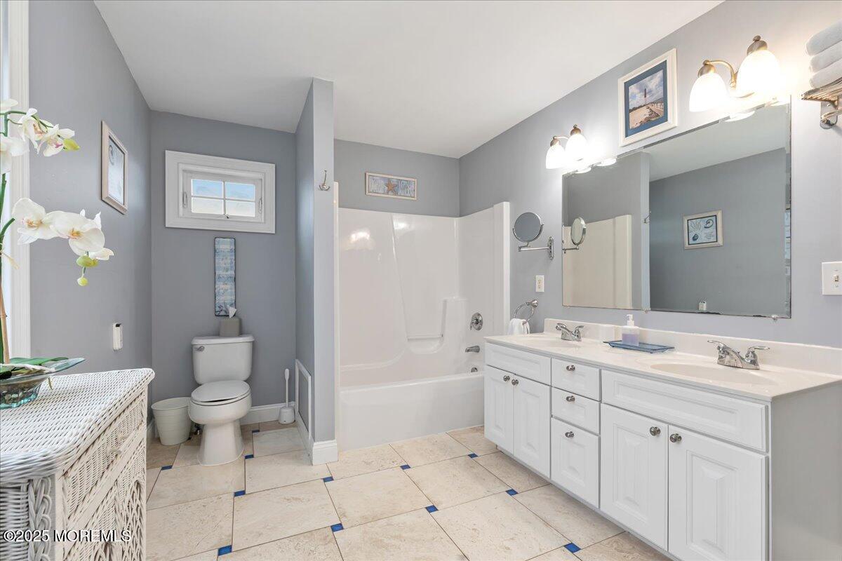 186 Flamingo Road Tuckerton, NJ 08087 - Photo 24 of 55 a spacious bathroom with a granite countertop sink a toilet a large mirror a bathtub and shower