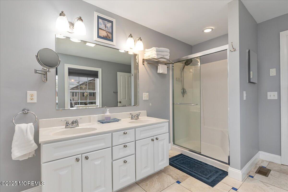186 Flamingo Road Tuckerton, NJ 08087 - Photo 25 of 55 a spacious bathroom with a shower sink and mirror