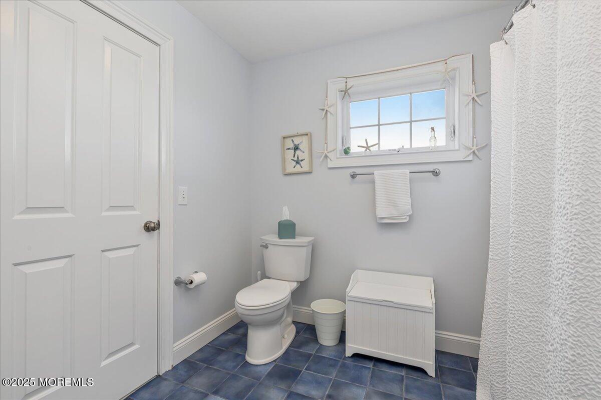 186 Flamingo Road Tuckerton, NJ 08087 - Photo 32 of 55 a white toilet sitting next to a bathroom sink