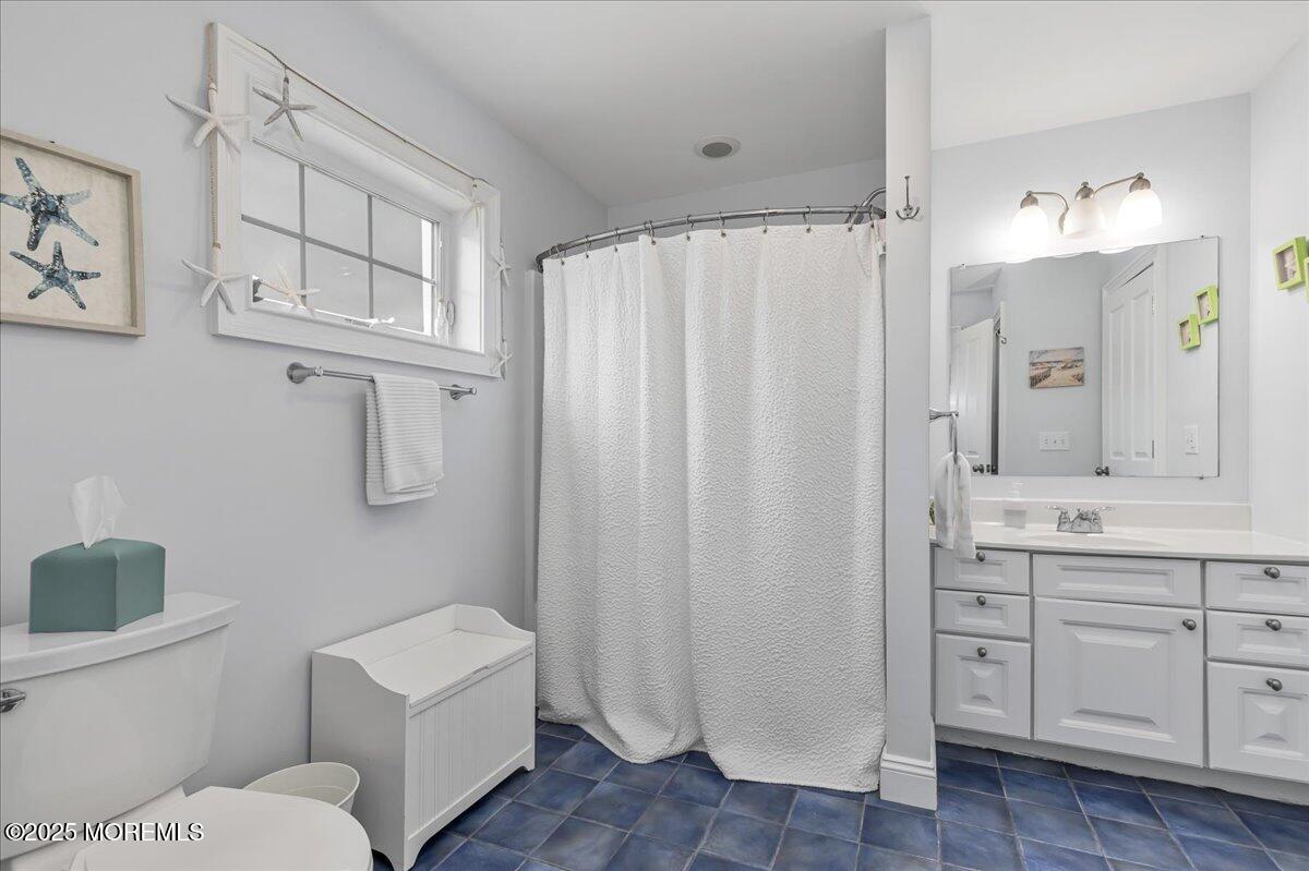 186 Flamingo Road Tuckerton, NJ 08087 - Photo 33 of 55 a bathroom with a toilet a sink and a mirror