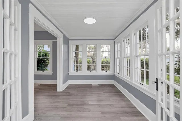 a view of an entryway with wooden floor and windows