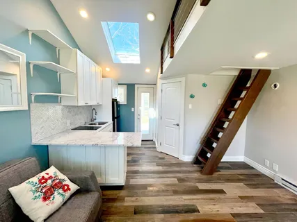 a living room with kitchen island granite countertop furniture and a view of kitchen