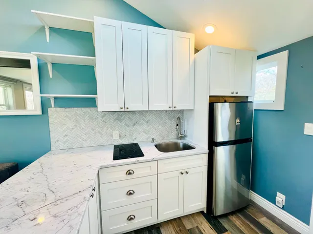 a kitchen with a refrigerator and cabinets
